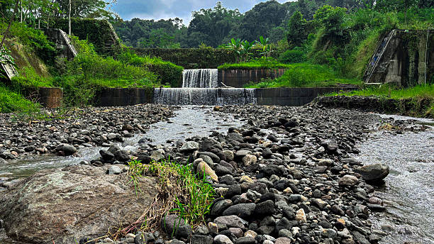 istock Small Waterfall and Rocky Stream in Tropical Landscape with Overcast Sky 2219974454