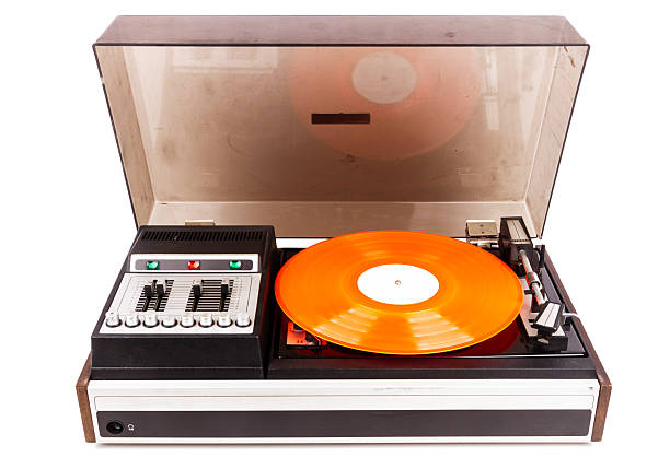 Vintage turntable record player with red vinyl isolated on white background.
