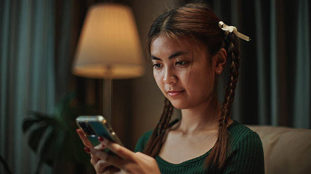 istock Young woman using smartphone at night. 2219977328
