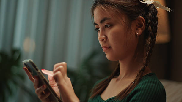 istock Young woman using smartphone at night. 2219977387