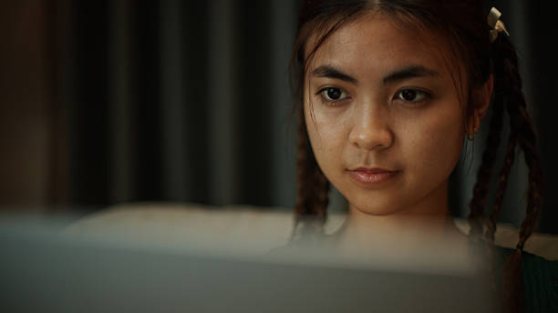 istock Woman using laptop on sofa at night. 2219977391