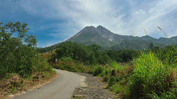 istock Cloud-Covered Volcanic Mountain in Lush Green Valley 2219977542