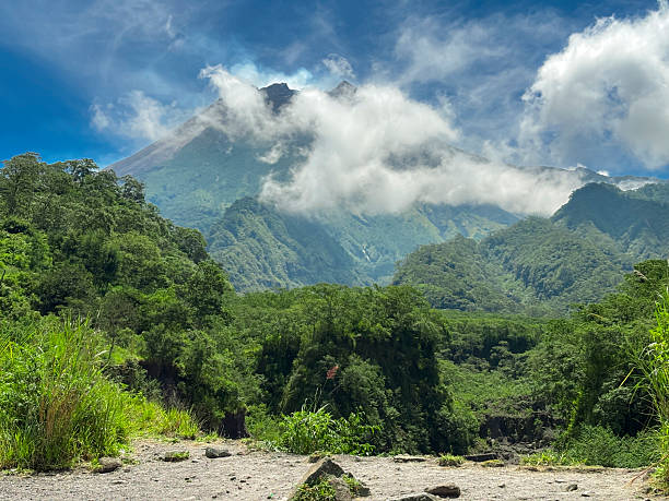 istock Cloud-Covered Volcanic Mountain in Lush Green Valley 2219977718