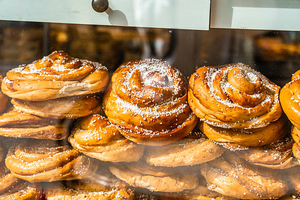 Freshly baked kanelbullar, traditional swedish cinnamon buns, are stacked and waiting for customers in a gothenburg bakery window
