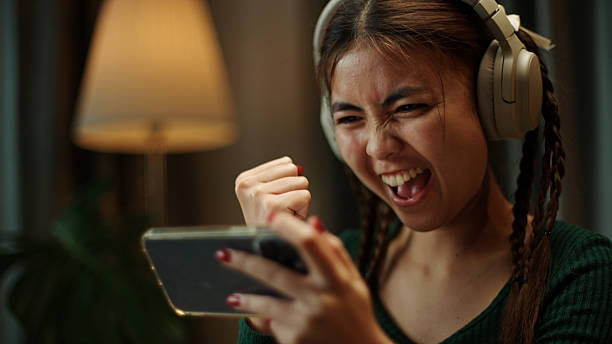 istock Teenager playing game on smartphone at night. 2219977945