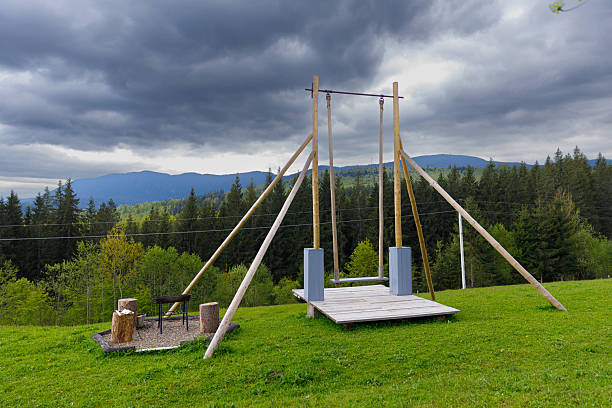 istock A Scenic View of a Swing Set Surrounded by Lush Greenery and Dramatic Clouds in the Background, Perfect for Outdoor Fun and Relaxation in a Natural Setting 2219979061