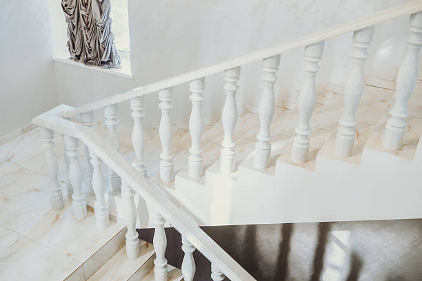 istock Elegant white staircase with decorative railing in bright interior space 2219981093