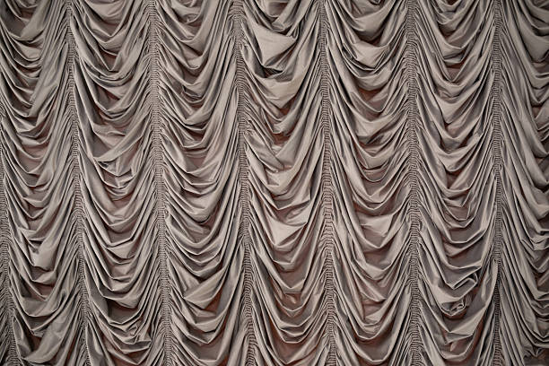 istock Elegant draped fabric in soft beige colors creating a textured backdrop 2219981108