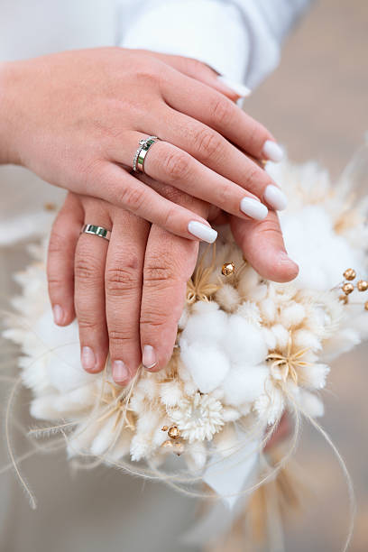 istock Wedding rings exchanged among delicate floral arrangement during a ceremony 2219981123