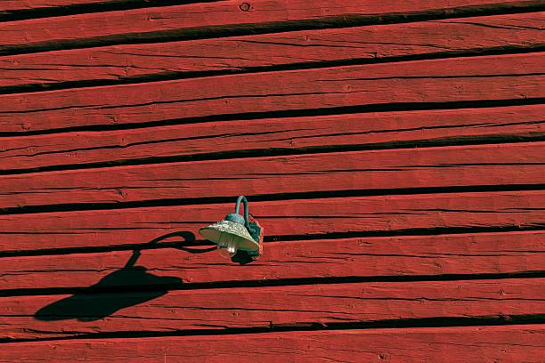 Old timber. Late afternoon. One metal lamp.\n\nThis is how Sweden looks when nobody watches. Quiet lines, hard light, and a lifetime of repainting.