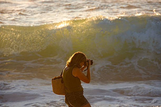 Facing the sea with her Camera