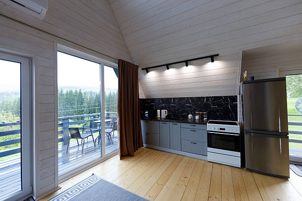 istock Modern Kitchen with Stunning Views: A Bright and Airy Space Surrounded by Nature, Featuring Sleek Cabinetry, Elegant Countertops, and Comfortable Outdoor Seating 2219988598