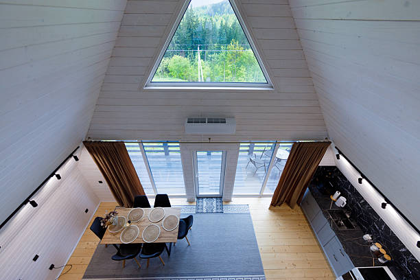 Charming A-Frame Cabin Interior with Modern Decor, Large Windows, and Scenic Nature Views, Perfect for Relaxation and Enjoying Beautiful Surroundings
