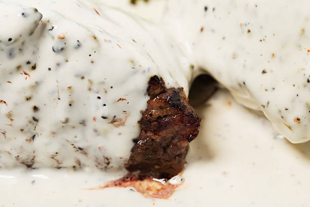 Steak with white mushroom sauce.