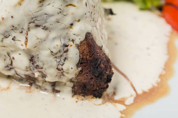 Steak with white mushroom sauce.