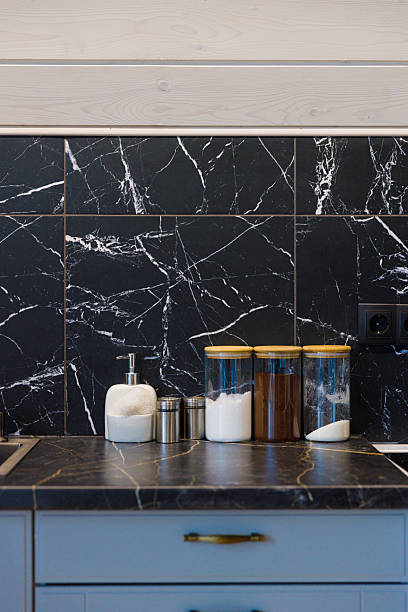 istock Elegant Kitchen Design Featuring Black and White Marble Backsplash with Stylish Containers and Modern Accessories for Functional and Aesthetic Appeal 2219990678