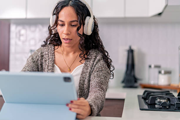 istock Young woman working remotely from airbnb apartment kitchen 2219990715