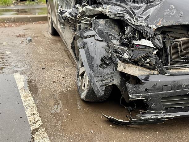 istock Car is severely damaged following a collision and road accident incident recently. This image features a detailed closeup of a car showing extensive frontend damage resulting from a serious accident 2219991046