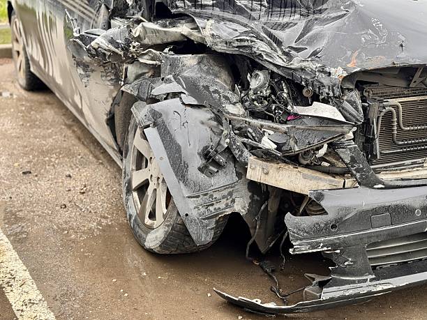 istock Car is severely damaged following a collision and road accident incident recently. This image features a detailed closeup of a car showing extensive frontend damage resulting from a serious accident 2219992480