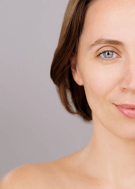 istock Beautiful Caucasian woman with grapefruit, grey background, Vitamin C benefits 2219992544