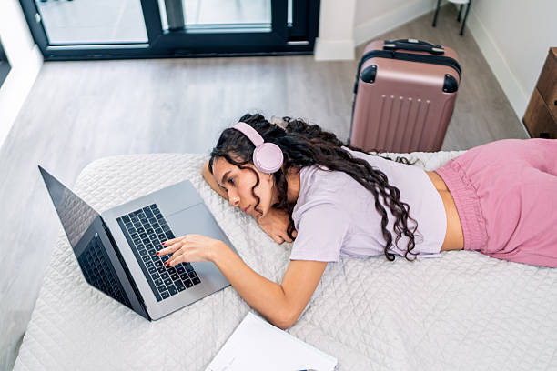 istock Young digital nomad working remotely from airbnb apartment 2219995848