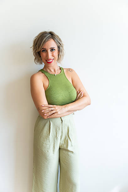 istock Smiling woman with crossed arms posing on white background 2219996287