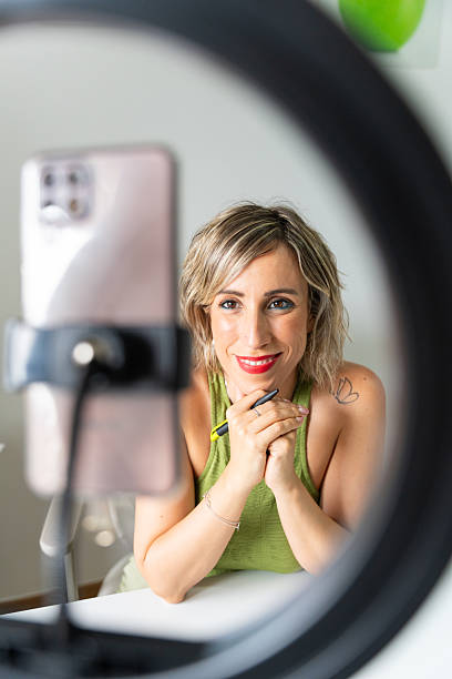 istock Influencer recording video content with ring light and smartphone 2219996298