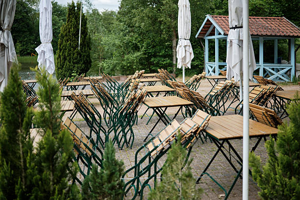 istock Outdoor Caf Setting with Tables and Umbrellas 2219997272