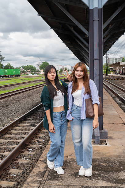 istock Two young woman at train station together 2219999186