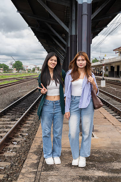 istock Two young woman at train station together 2219999222