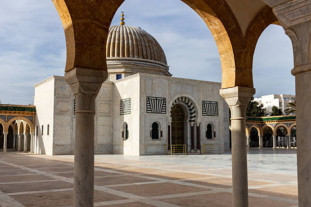 istock A building with a large dome is framed by arches in a courtyard setting. 2219999904