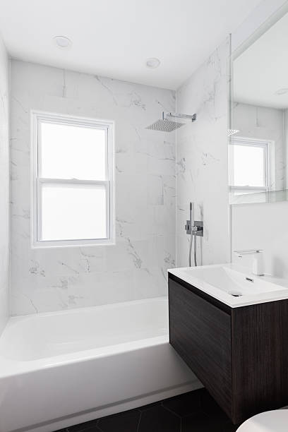 istock A bathroom with a wood cabinet and marble tiled shower. 2220000211
