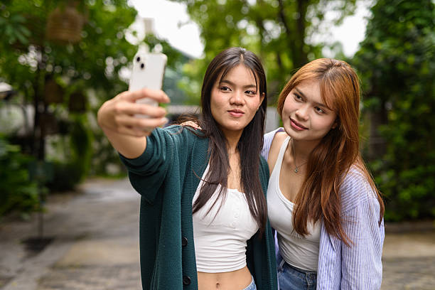 istock Two young woman together in park during summer 2220000896