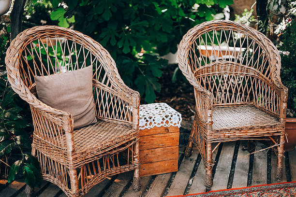 istock Cozy wicker chairs with decorative table in a natural outdoor setting during daylight hours 2220001720