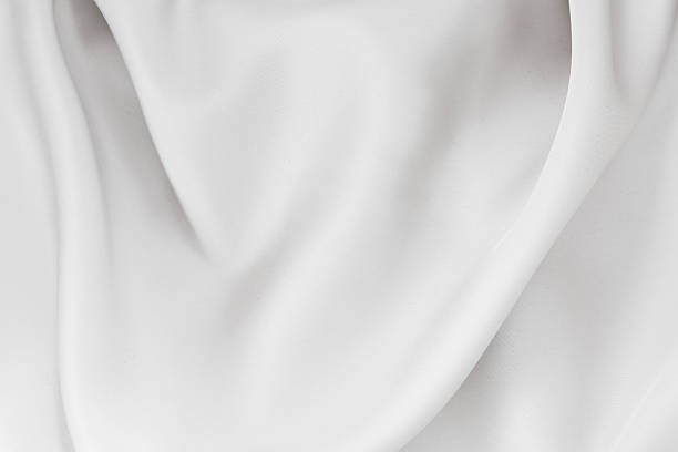 istock Soft white fabric drapes elegantly under soft lighting in a cozy indoor space during the afternoon 2220001908