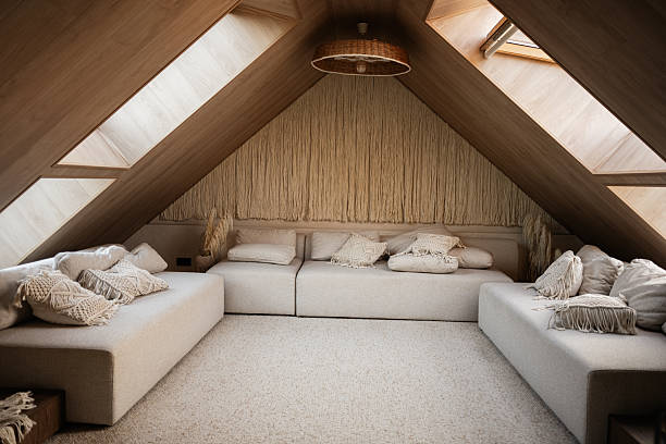 istock Cozy attic living room with sofas and natural light through skylights 2220002036
