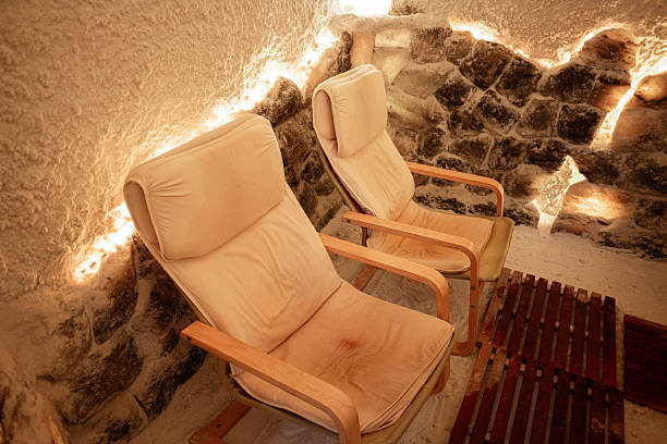 istock Comfortable chairs in a cozy salt room with textured walls and subtle lighting 2220002041