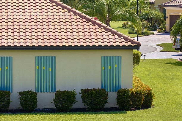 istock Storm shutters mounted on Florida house windows for hurricane protection. Preparing for natural disaster 2220002385