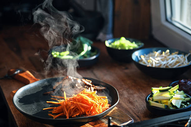 istock Preparing Bibimbap Korean Rice Dish in Domestic Kitchen 2220004166