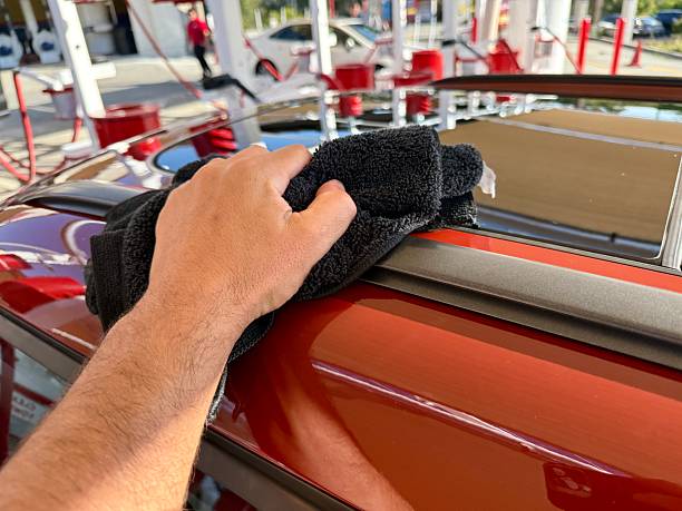 istock Man hand cleaning car with microfiber cloth at car wash 2220004307