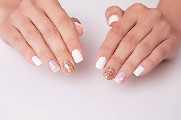 istock Female hands with romantic manicure nails, white gel polish 2220004754