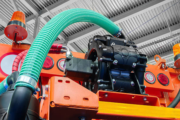 istock Large orange machine with many white pipes and wires industrial background for a web banner template page 2220007766