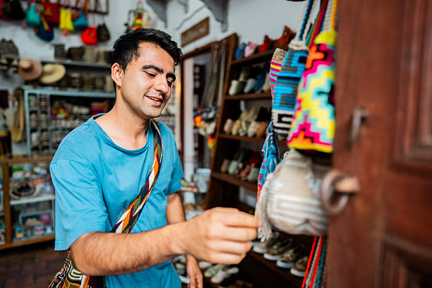istock Young customer man buying souvenir at retail place 2220009918