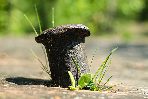close-up of an old metal rod embedded in a stone surface with bokeh light effect background. outdoor nature landscape. quarry tool ruins