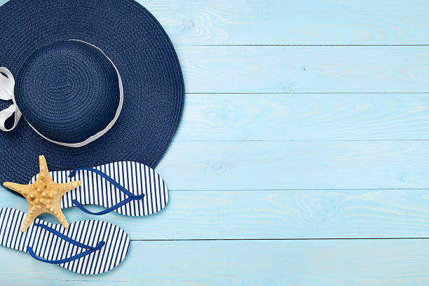 istock Blue beach accessories on wooden background, top view. Copy space for text 2220012417