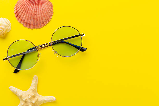 istock Blue sunglasses on color background, top view 2220012430