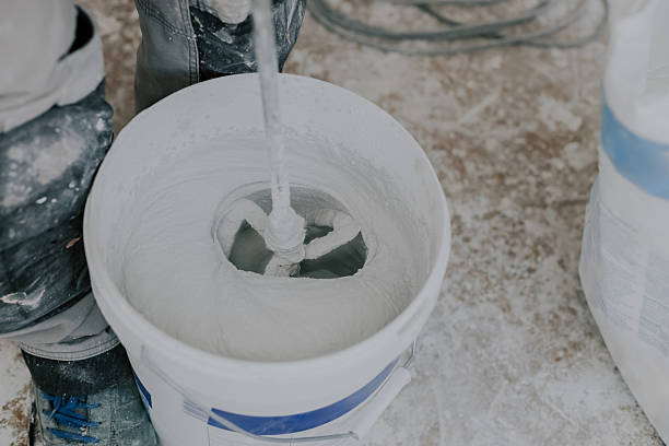 istock A young man beats putty with a construction mixer. 2220018918