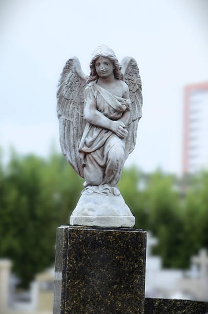 istock Image of a kneeling angel decorating a grave 2220020032