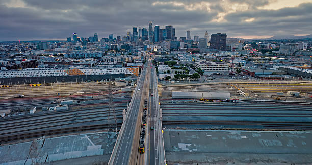 Light Rail, Heavy Cargo Railways and Downtown Los Angeles in a Wide Angle Drone Shot Looking West