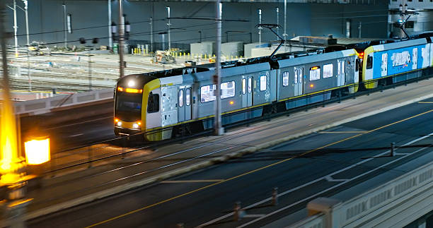 istock Wide Angle Drone Shot Looking Down on a Los Angeles Metro Train Headed East at Night 2220023089